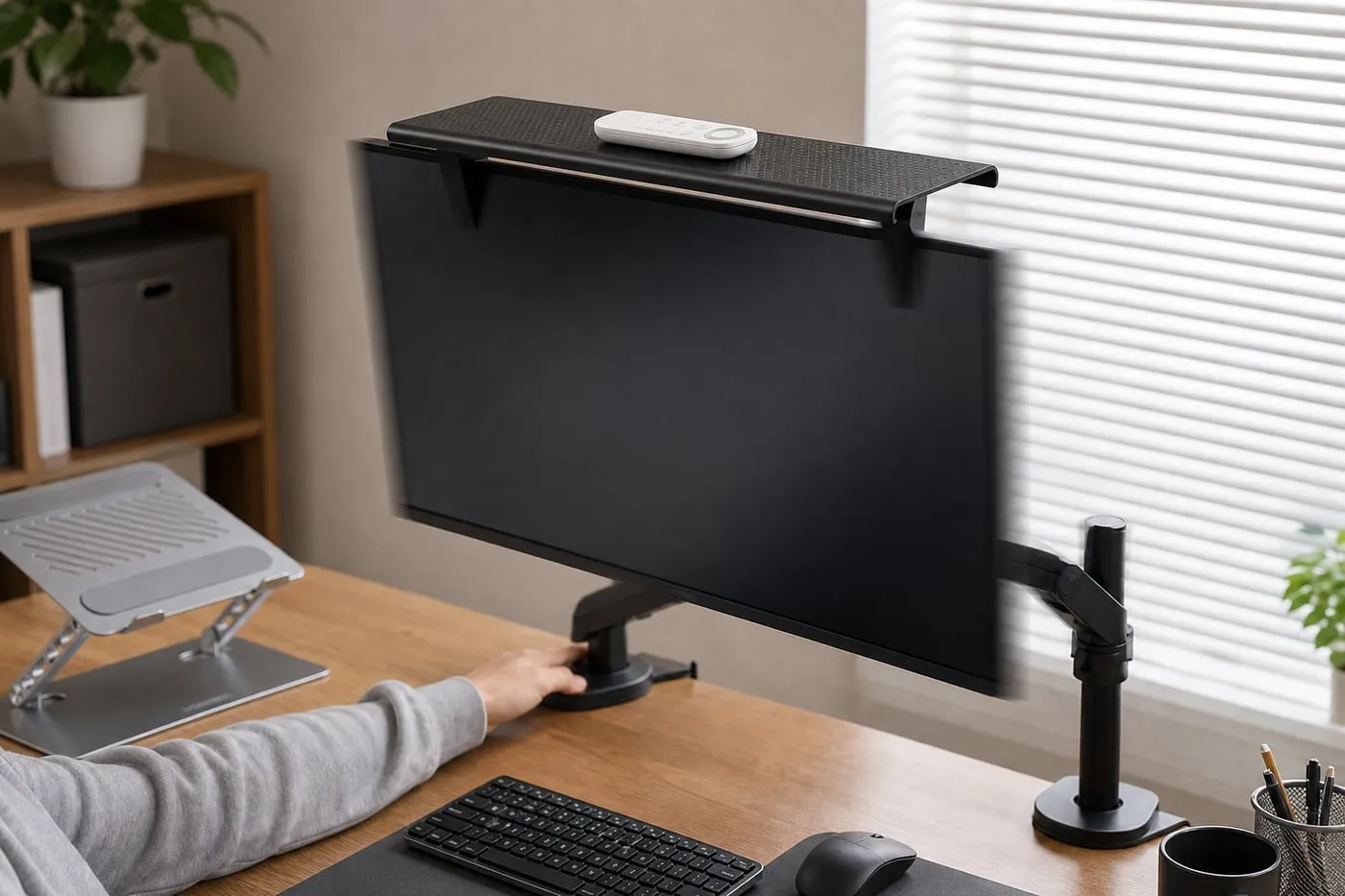 Screen-top shelf on a monitor arm with one lightweight remote