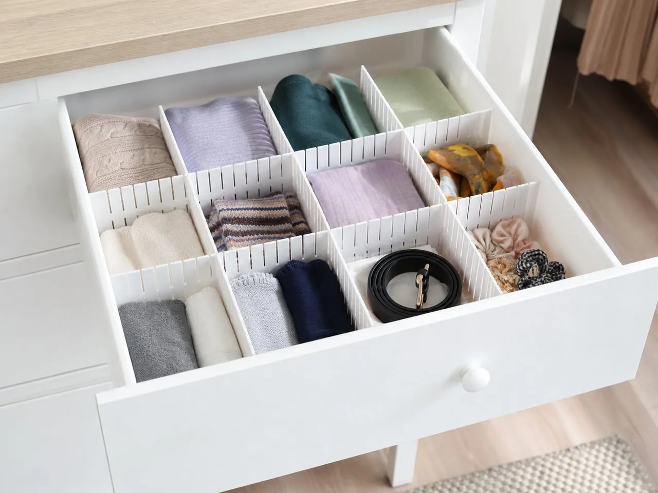 White slotted plastic partitions separating socks and small accessories