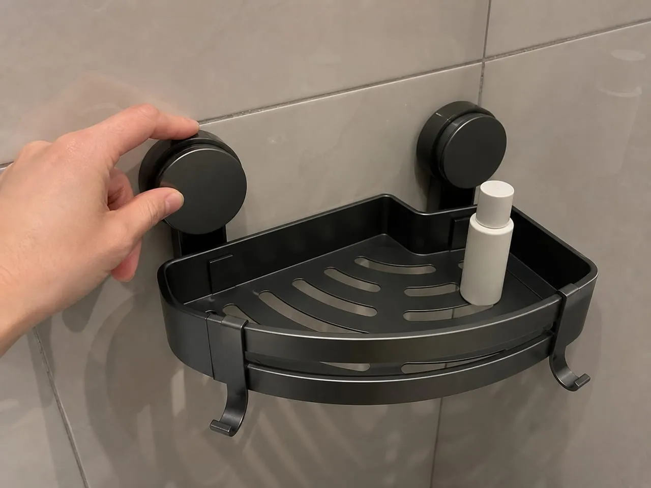 Checking a round suction cup against a large glossy tile